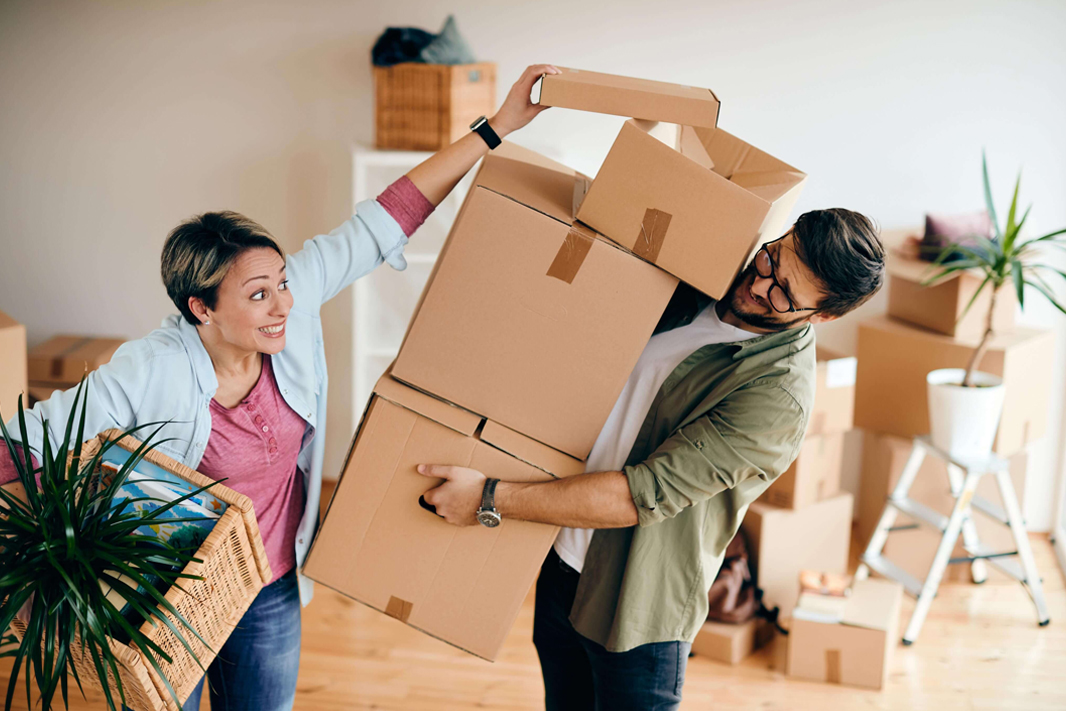 Movers carefully preparing packed boxes
